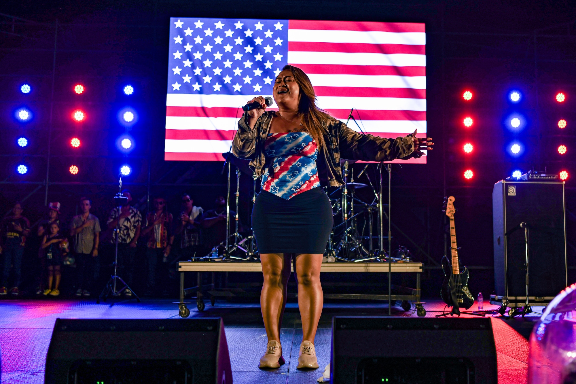 A woman sings the national anthem.
