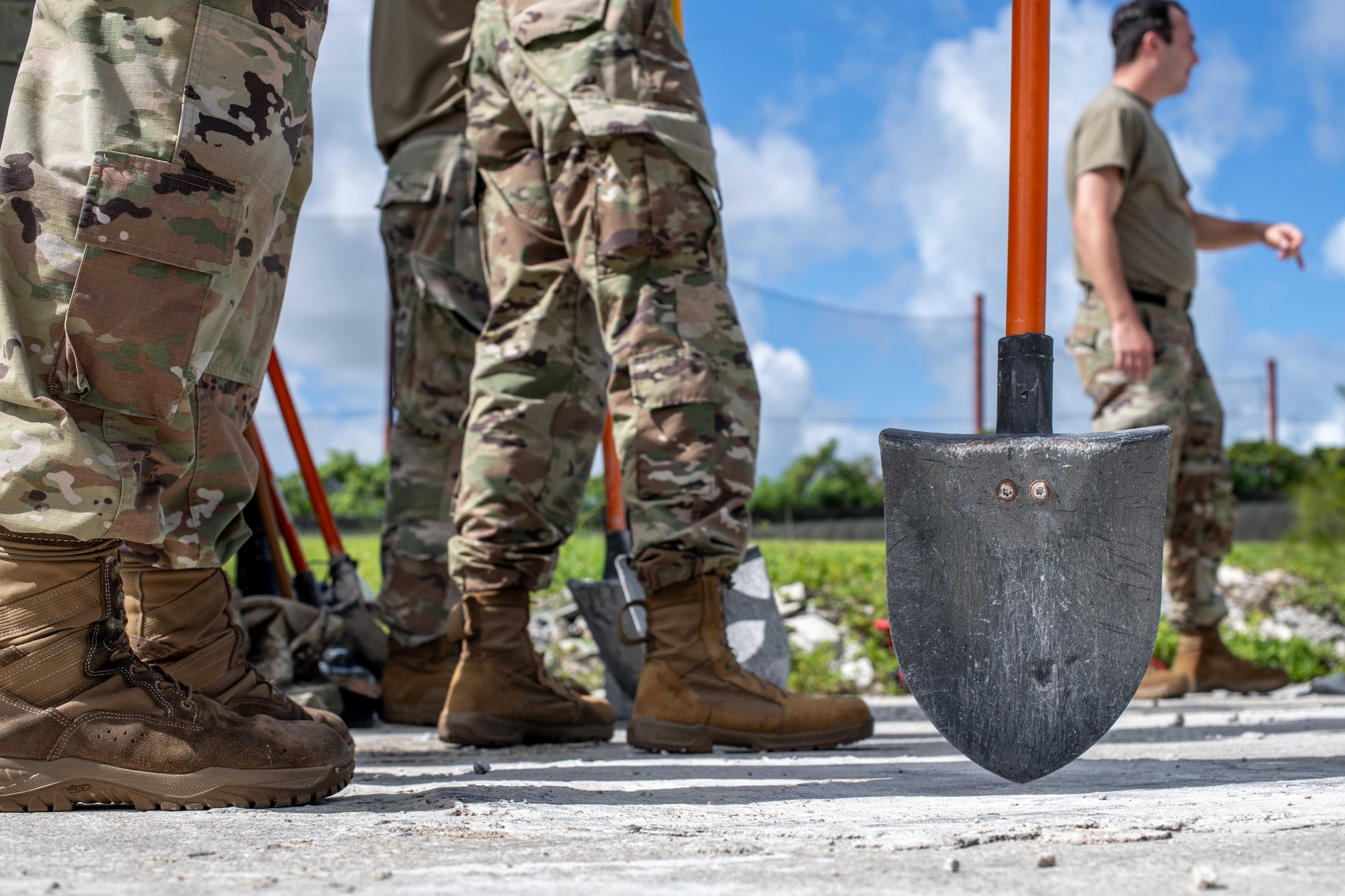 military members prepare by holding shovels on the flightline