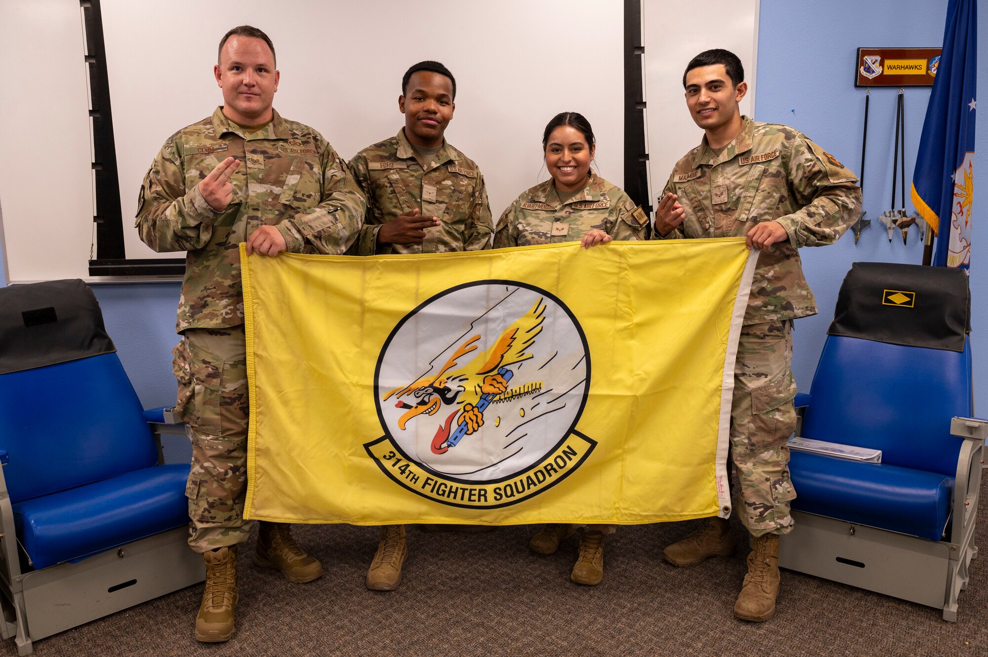 Airmen from the 314th Fighter Squadrons Aviation Resource Management pose for a photo with their squadron flag at Holloman Air Force Base, New Mexico, July 15, 2024.