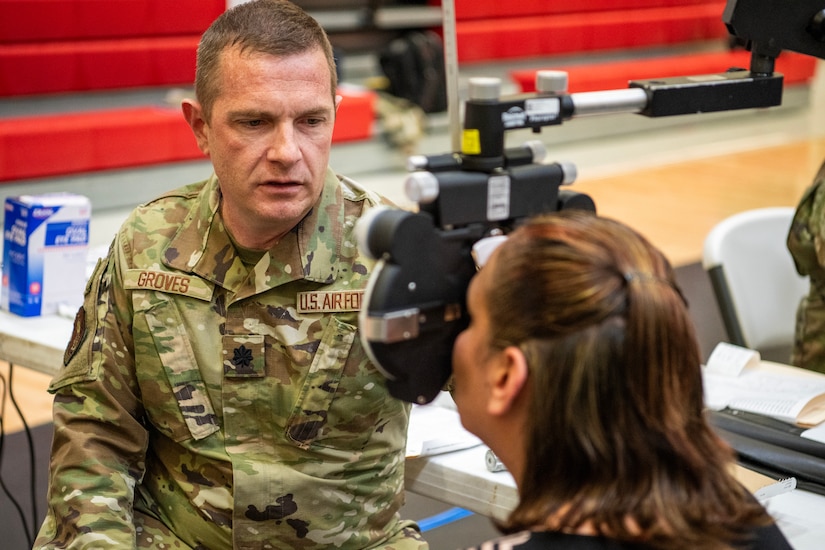 U.S. Air Force Lt. Col. Robert Groves, an optometrist assigned to the 157th Medical Group, Oklahoma Air National Guard, treats a patient during the Blackfeet tribal Health - Operation Walking Shield, Innovative Readiness Training medical mission at Browning High School in Browning, Mont, July 17, 2024.