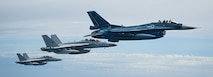 Two U.S. Navy E/A 18-G Growlers and one Japanese Air Self-Defense Force F-2 fly in formation during a French PEGASE mission for an aerial interaction, July 19, 2024.