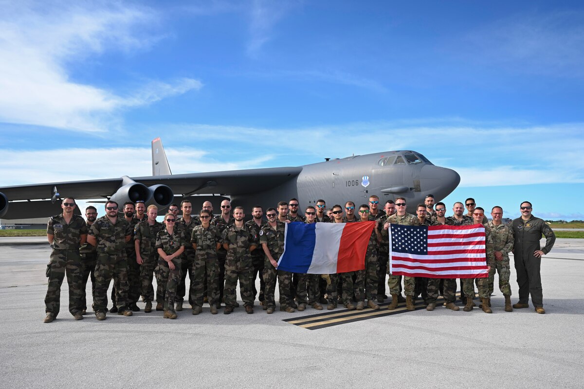 U.S. Airmen from the 20th Expeditionary Bomb Squadron and French Air Force members stand together after a joint exercise at Andersen Air Force Base, Guam, July 20, 2023. These exercises demonstrate the U.S. commitment to the region by building interoperability, multilateral cooperative arrangements alongside Allies and partners, advancing common interests and ensuring a free and open Indo-Pacific region. (U.S. Air Force photo by Airman 1st Class Nia Jacobs)