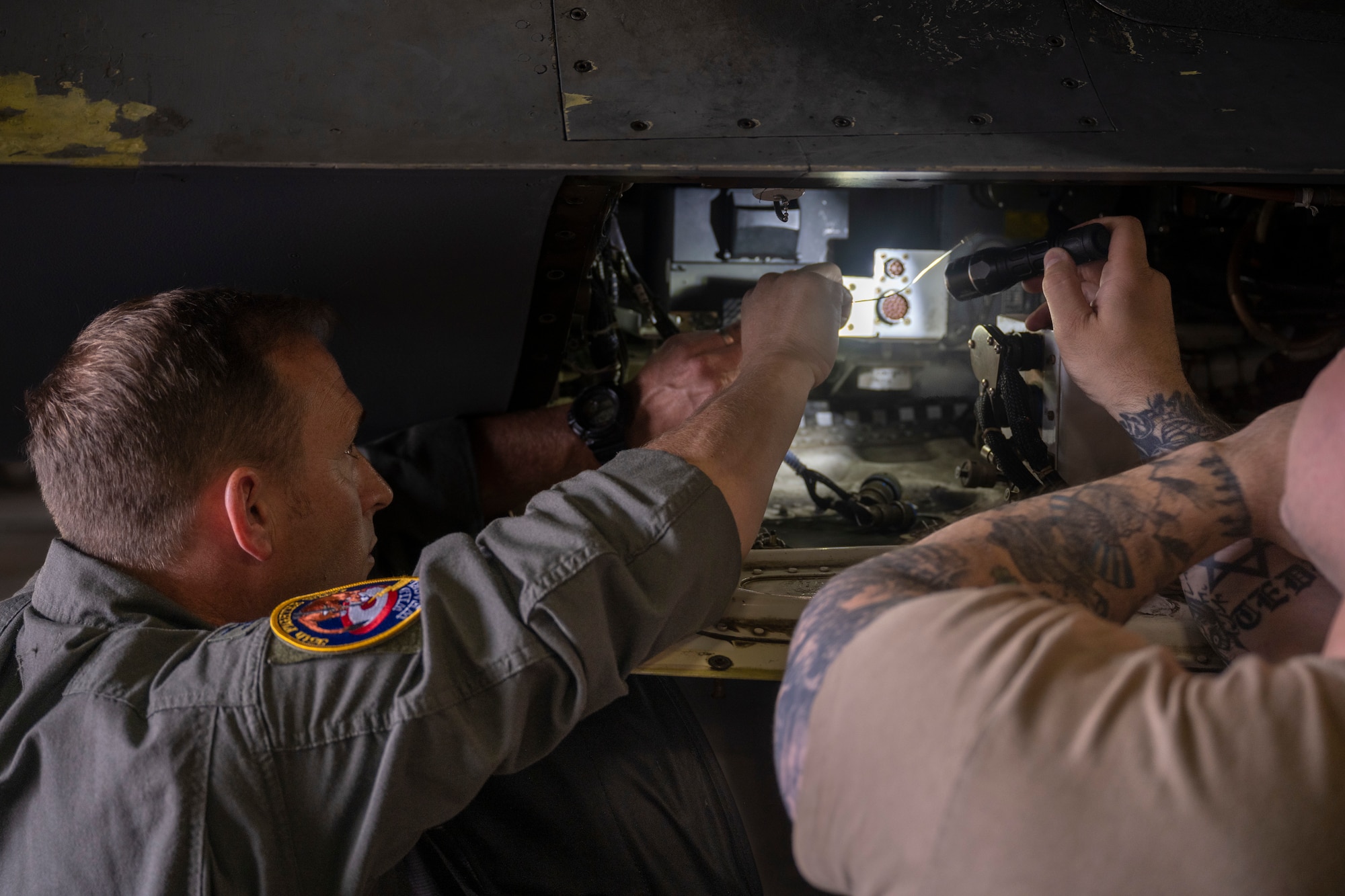 U.S. Air Force Col. Paul Davidson, 35th Fighter Wing commander, and Tech. Sgt. Teddy Longnecker, 13th Fighter Generation Squadron F-16 avionics craftsmen, perform routine maintenance on an F-16 Fighting Falcon during a Wild Weasel Walkthrough at Misawa Air Base, Japan, July 11, 2024.