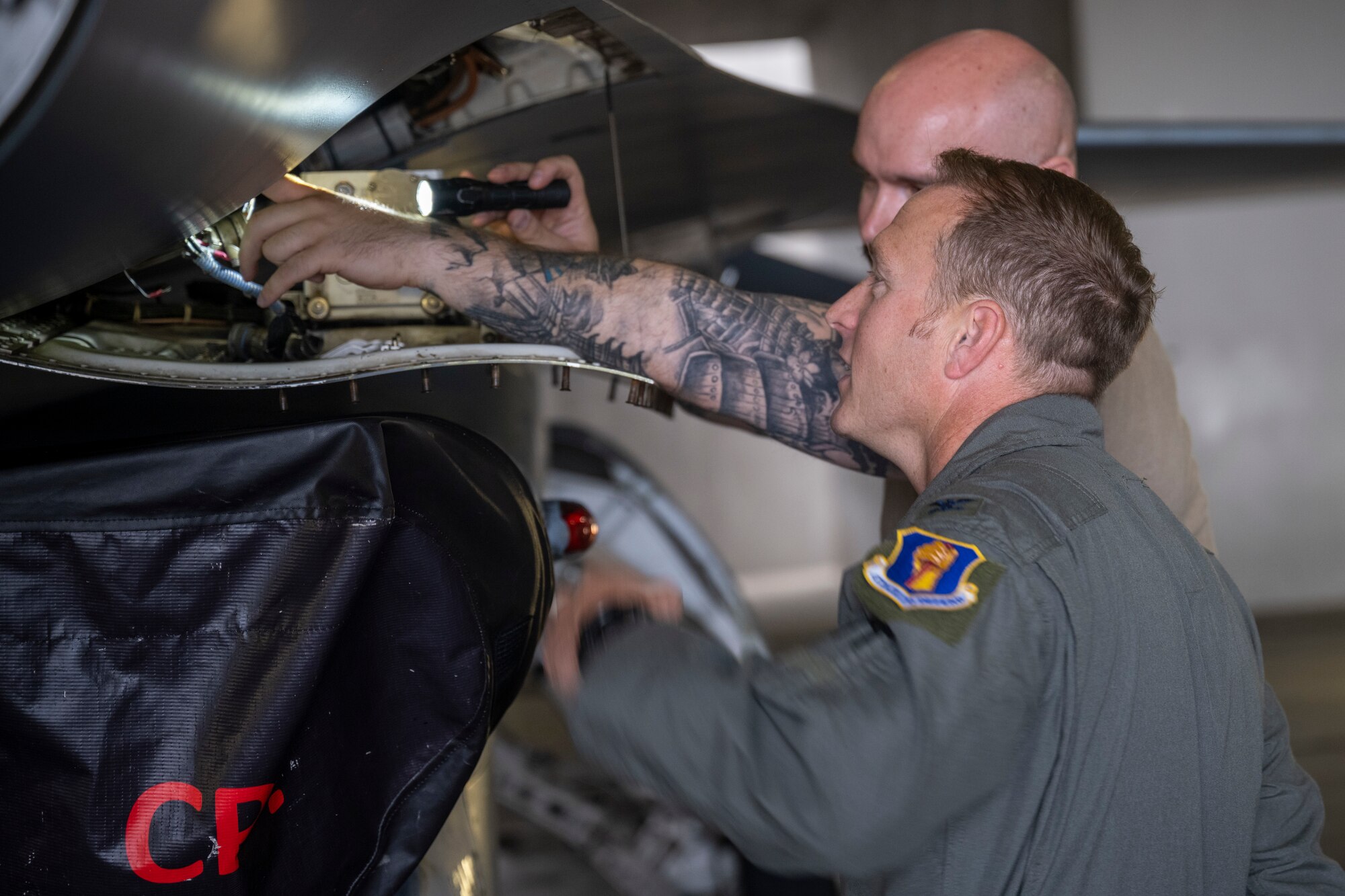 U.S. Air Force Col. Paul Davidson, 35th Fighter Wing commander, inspects the inner workings of an F-16 during a Wild Weasel Walkthrough at Misawa Air Base, Japan, July 11, 2024.