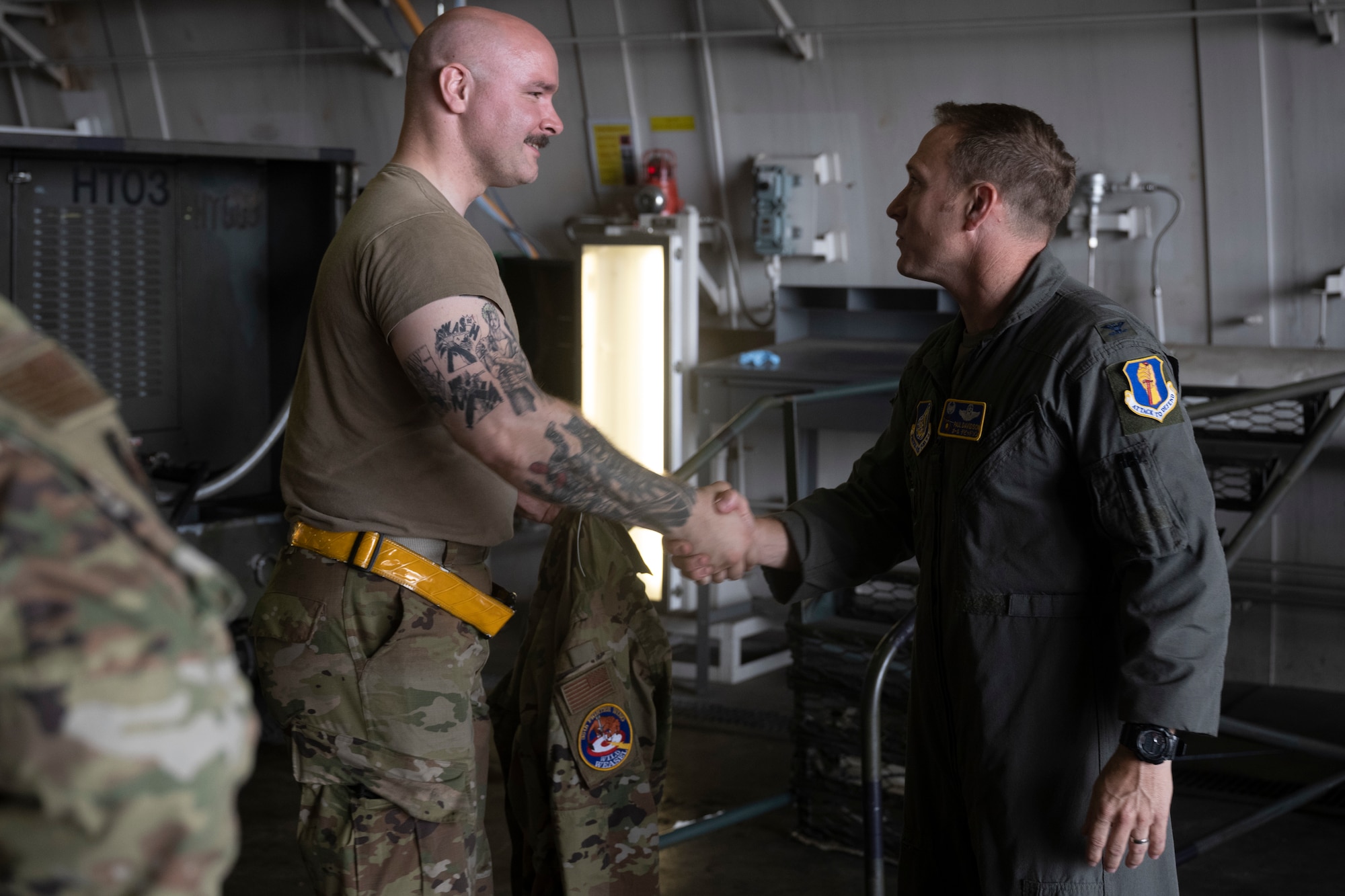 U.S. Air Force Col. Paul Davidson. 35th Fighter Wing commander, exchanges patches with Tech. Sgt. Teddy Longnecker, 13th Fighter Generation Squadron F-16 avionics craftsmen, during a Wild Weasel Walkthrough at Misawa Air Base, Japan, July 11, 2024.