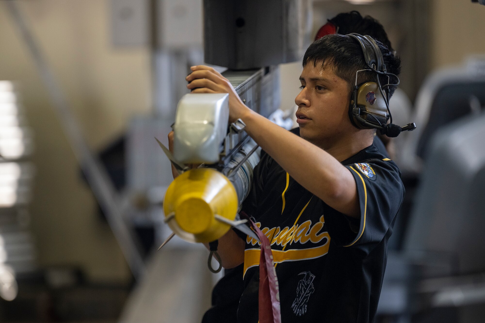 U.S. Air Force Airman 1st Class Eli Hernandez, 14th Fighter Generation Squadron load crew member, secures a missile during the 35th Maintenance Group’s 2nd quarter weapons load competition at Misawa Air Base, Japan, July 18, 2024.