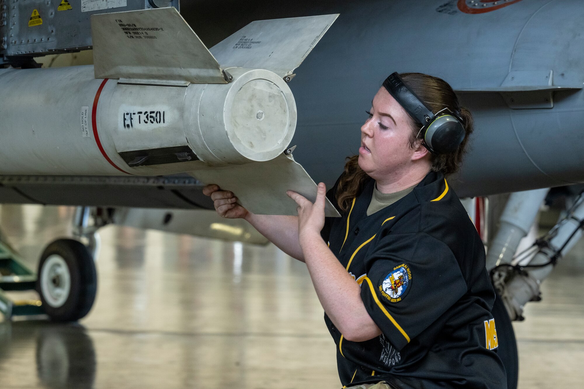 U.S. Air Force Senior Airman Katelyn Naler, 14th Fighter Generation Squadron load crew member, examines a missile during the 35th Maintenance Group’s 2nd quarter weapons load competition at Misawa Air Base, Japan, July 18, 2024.