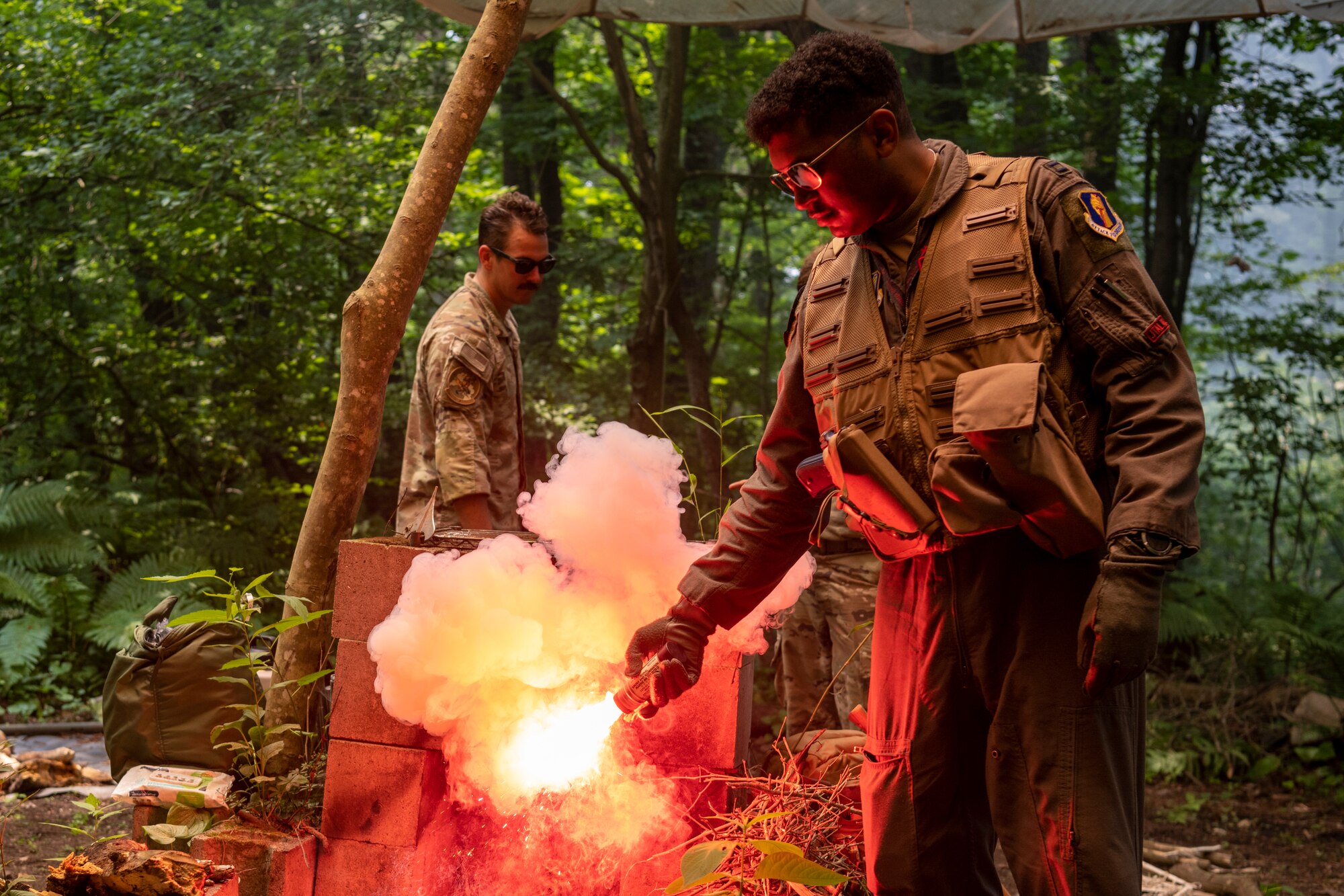 U.S. Air Force Capt. Isaiah Butcher, 13th Fighter Squadron pilot, ignites a flare during a Combat Survival Training exercise led by Survival, Evasion, Resistance, Escape (SERE) specialists at Draughon Range near Misawa Air Base, Japan, July 16, 2024.