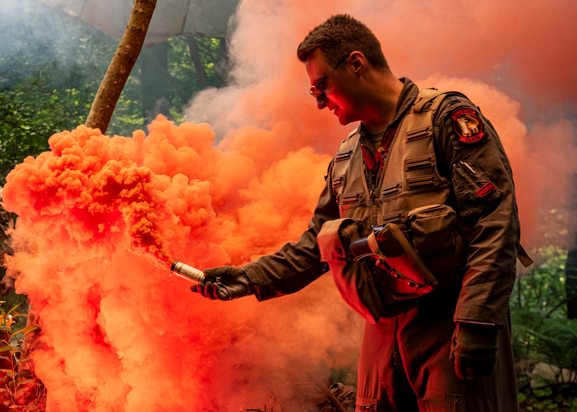 U.S. Air Force Capt. Charles Trader, 13th Fighter Squadron pilot, ignites a flare during a Combat Survival Training exercise led by Survival, Evasion, Resistance, Escape (SERE) specialists at Draughon Range near Misawa Air Base, Japan, July 16, 2024.