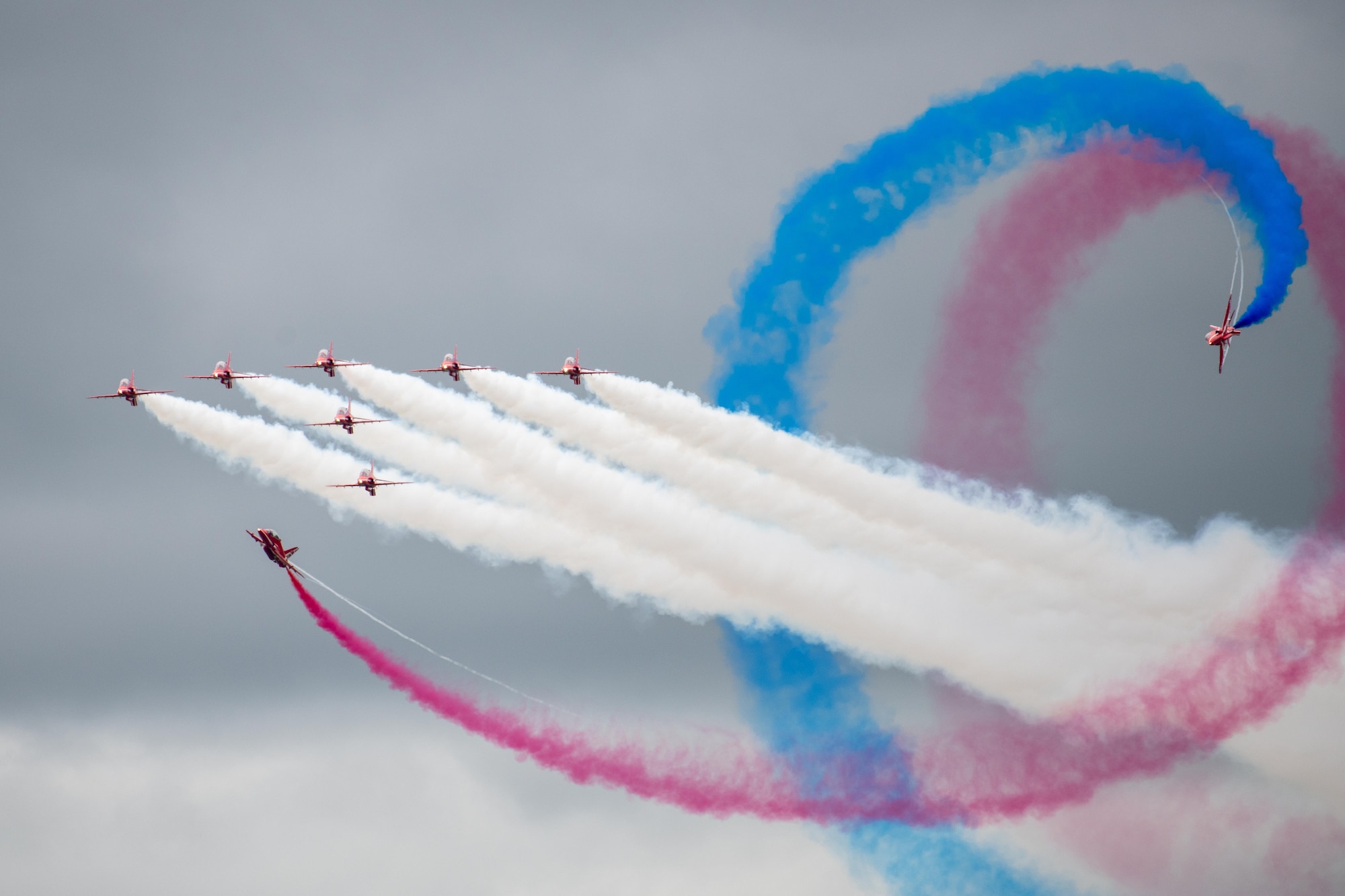 The Royal Air Force Red Arrow aeronautical team conduct an aerial demonstration