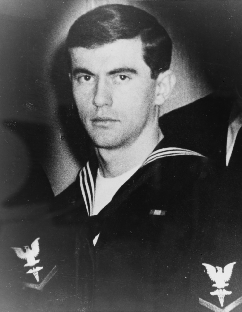 A man in uniform poses for a photo.