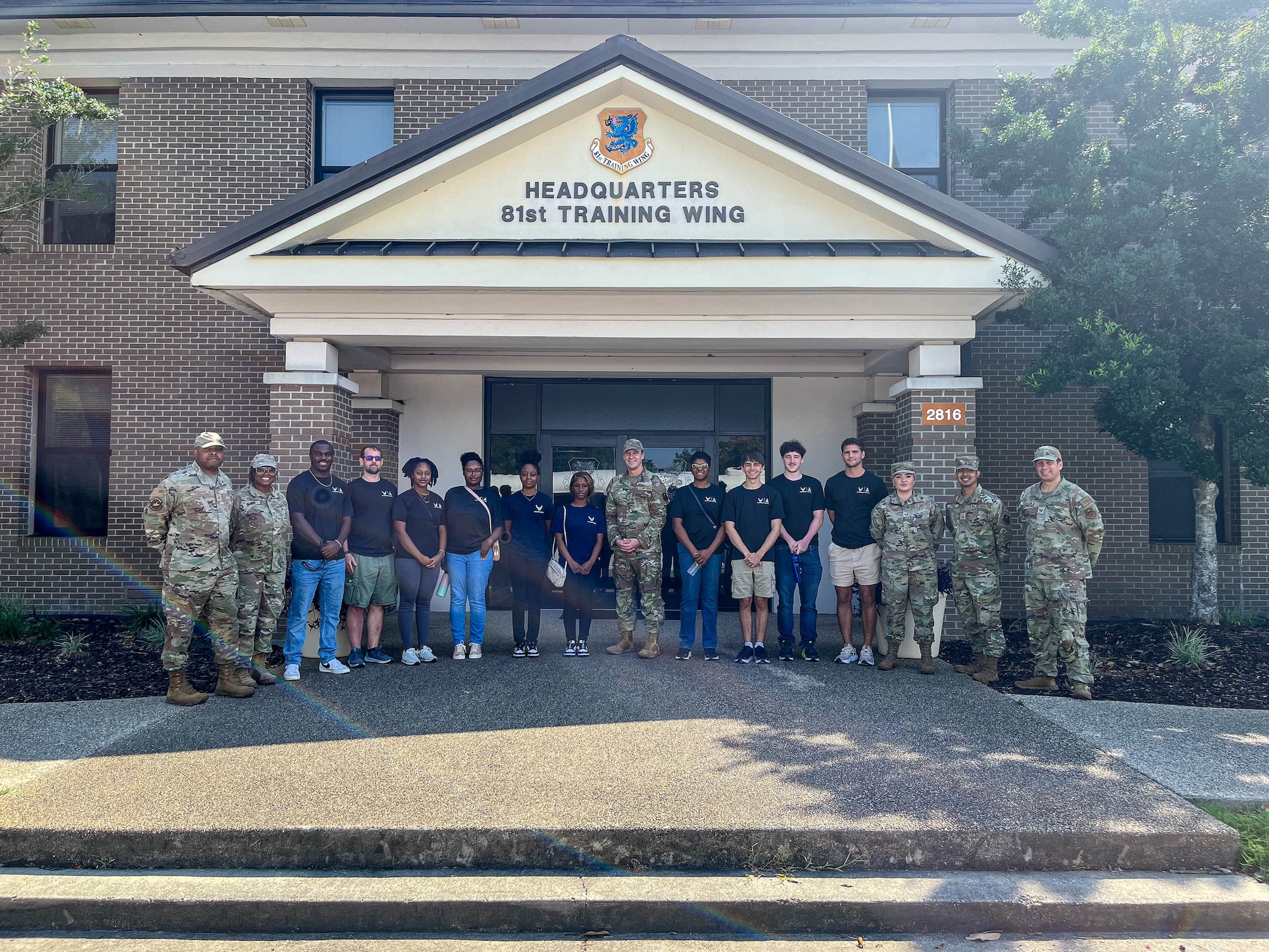 U.S. Air Force Chief Master Sgt. Michael Venning, 81st Training Wing command chief, poses with recruits from the 331st Recruiting Squadron during a tour of Keesler Air Force Base, Mississippi, July 11, 2024.