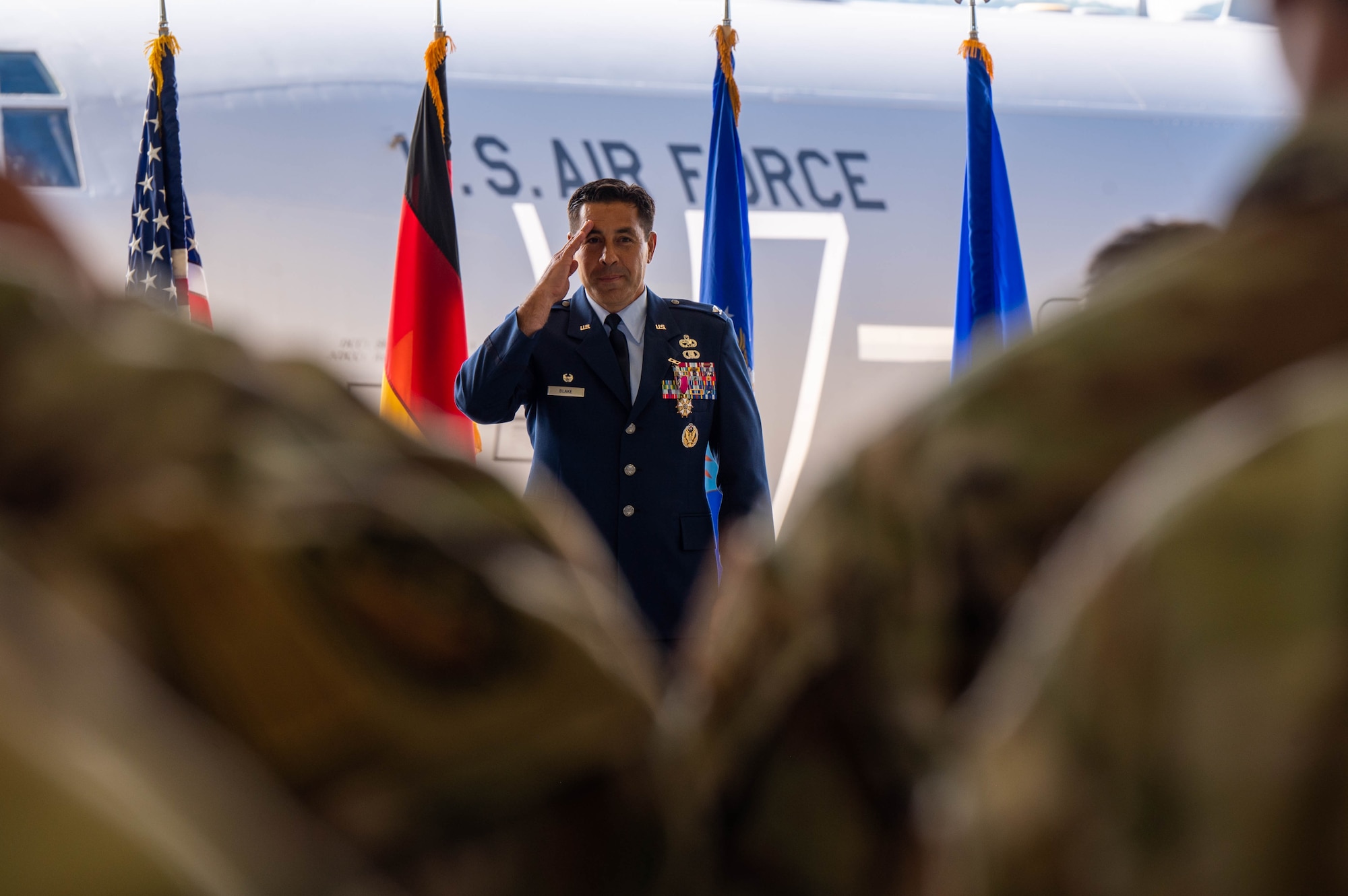 Outgoing MXG commander salutes his Airmen.