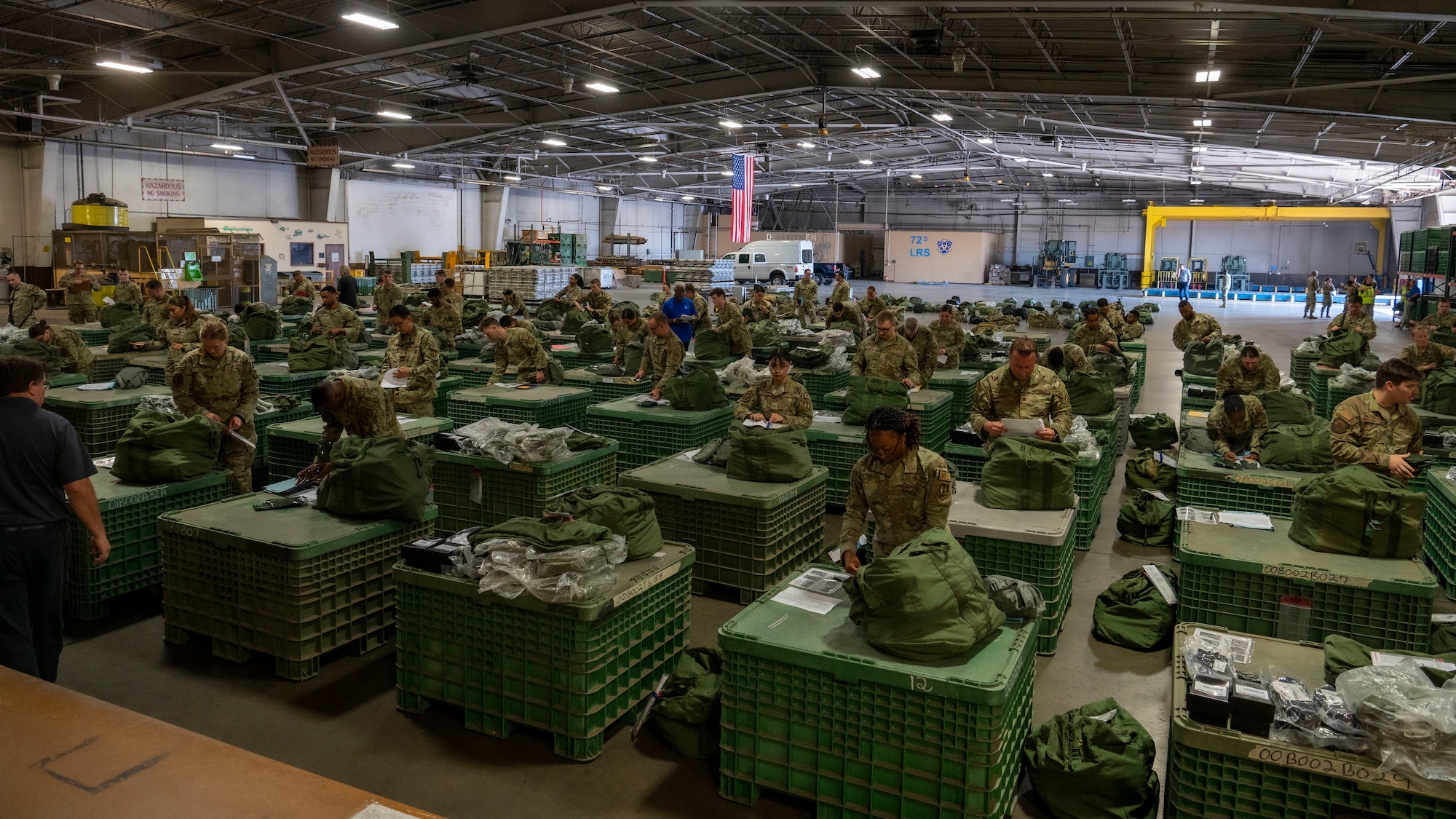 Airmen in a room with deployment kits