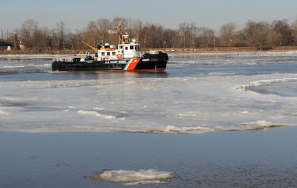 The Coast Guard Cutter Capstan, a 65-foot ice-breaking tugboat homeported in Philadelphia, breaks ice on the Delaware River, near the Burlington-Bristol Bridge, Thursday, Jan. 9, 2014.