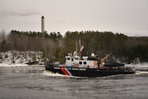 The crew of the Coast Guard Cutter Shackle (WYTL 65609) transits up the Penobscot River in Maine to break ice on Feb. 16, 2022