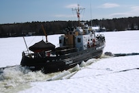 The Coast Guard Cutter Tackle breaks ice on the Kennebec River near Bath, Maine today for flood relief.