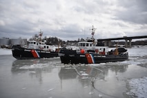 The crews of the Coast Guard Cutters Shackle (WYTL 65609) and Tackle (WYTL 65604) transit up the Penobscot River in Maine to break ice on Feb. 16, 2022. Th