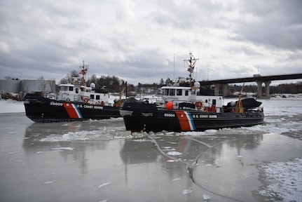 The crews of the Coast Guard Cutters Shackle (WYTL 65609) and Tackle (WYTL 65604) transit up the Penobscot River in Maine to break ice on Feb. 16, 2022. Th