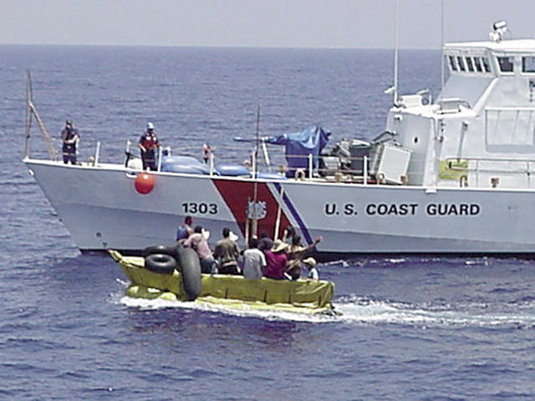 The Coast Guard Cutter Matagorda comes alongside a 15-foot boat with 12 Cuban migrants aboard May 24 about 20 miles south of Key West, Fla