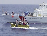 The Coast Guard Cutter Matagorda comes alongside a 15-foot boat with 12 Cuban migrants aboard May 24 about 20 miles south of Key West, Fla