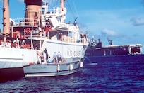 A Navy patrol boat, the Whidbey Island, moors alongside a Coast Guard cutter before the cutter gets underway assisting in Operation Able Vigil between Cuba and the Florida Keys.