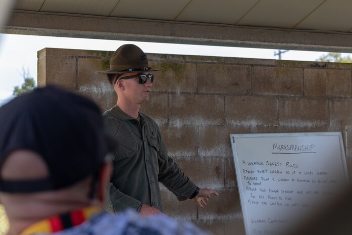 U.S. Marine Corps Sgt Liam Mueller, primary marksman instructor with Weapons Field Training Battalion, Marine Corps Recruit Depot, gives a weapons safety brief as part of the 2024 Educators Workshop at Marine Corps Base Camp Pendleton, California, July 17, 2024. Participants of the workshop visited Marine Corps Recruit Depot San Diego and MCB Camp Pendleton to observe recruit training and gain a better understanding about the transformation recruits undergo to become United States Marines. Educators also received classes and briefs on benefits provided to service members in the United States armed forces. (U.S. Marine Corps photo by Lance Cpl. Jacob B. Hutchinson)