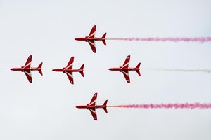 The Royal Air Force Red Arrow aeronautical team conduct an aerial demonstration