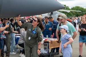 An Airman speaks with attendees during the Royal International Air Tattoo