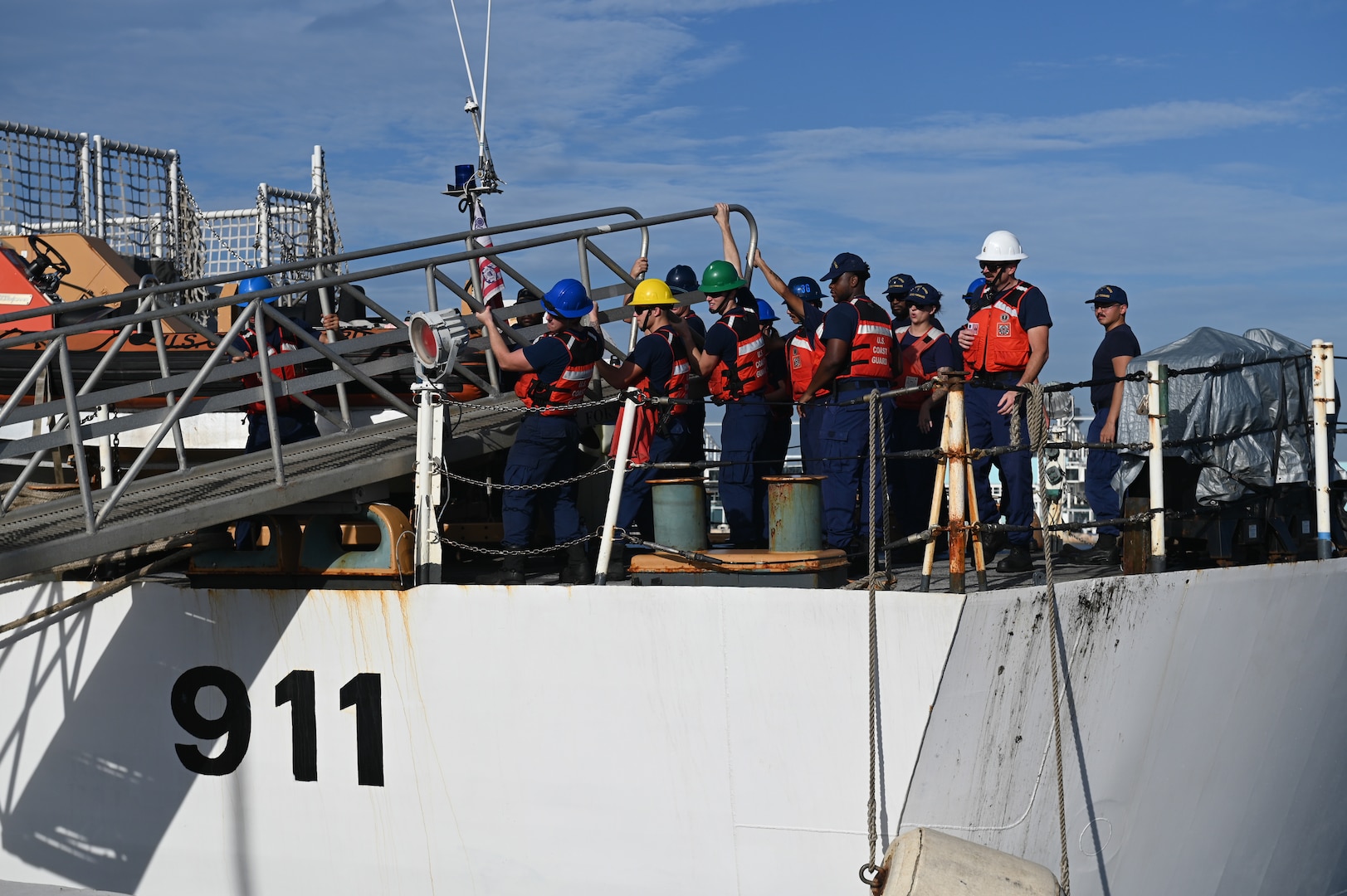 Crew members of the Coast Guard Cutter Forward extending the brow to the pier at Port Everglades, Florida, July 22, 2024. Illicit narcotics are offloaded onto the pier and transferred to partner agencies for destruction. (U.S. Coast Guard photo by Petty Officer 3rd Class Nicholas Strasburg)