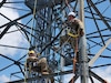 Pennsylvania Air National Guardsmen Staff Sgt. Jeremiah Leonard, left, and Tech. Sgt. Shane Miller, right, with the 258th Air Traffic Control Squadron in Johnstown, Pennsylvania, prepare to train on a pick-off rescue while on a radar tower during their two-week training exercise from June 3, 2024 to June 16, 2024. The 258th Air Traffic Control Squadron is a geographically separated unit of the 171st Air Refueling Wing and serves an essential mission by providing air traffic control services both stateside and overseas to civil, military, and even presidential aircraft while also maintaining mobile readiness to deploy.  (U.S. Air National Guard Photo)