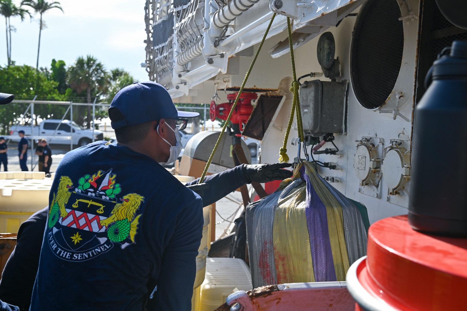 Crew members of the Coast Guard Cutter Forward hoisting bales of cocaine from a secure space below deck at Port Everglades, July 22, 2024. Drugs interdicted by the Coast Guard are transferred to partner agencies such as the Drug Enforcement Agency for destruction. (U.S. Coast Guard photo by Petty Officer 3rd Class Nicholas Strasburg)