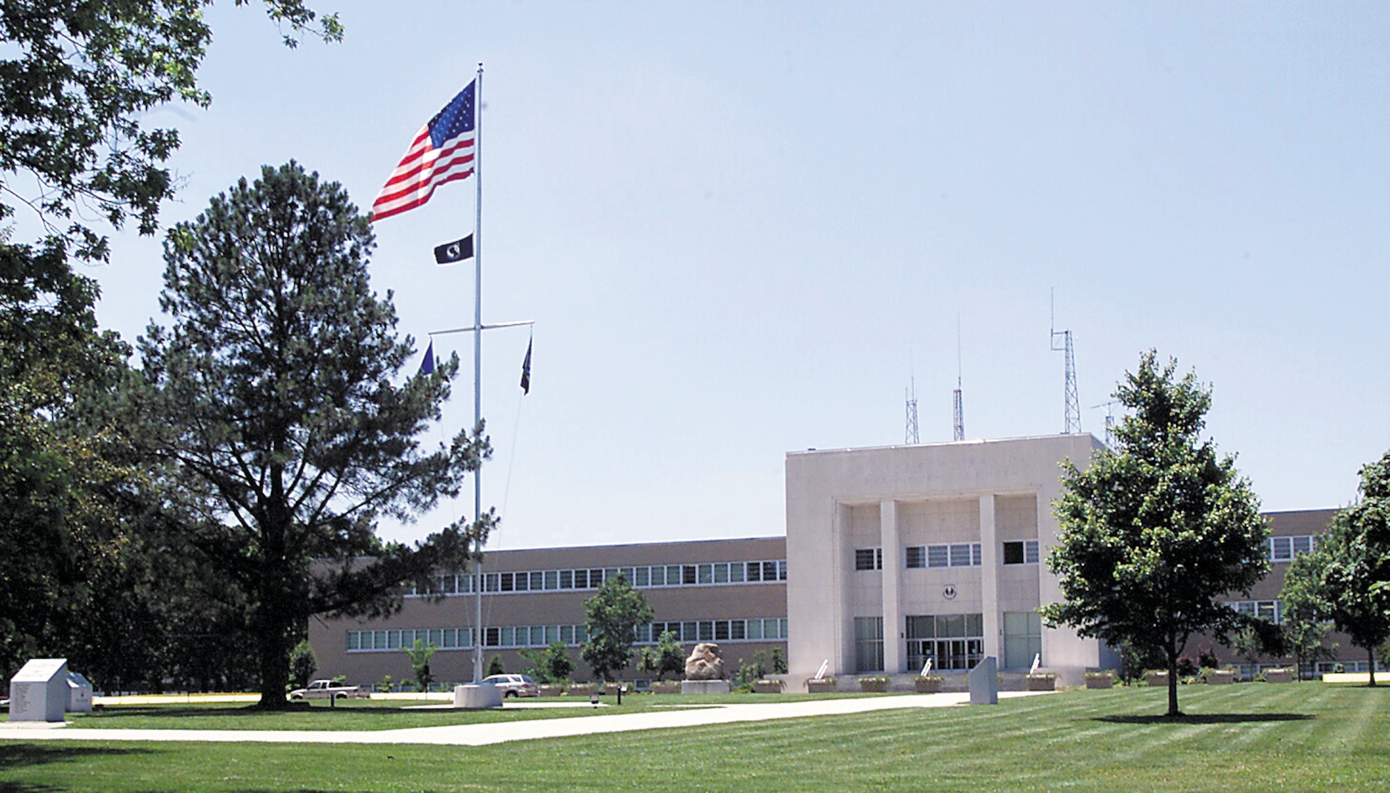 The American flag flies outside the Administration & Engineering Building at Arnold Air Force Base, Tenn. Events occur twice each weekday at Arnold to honor the nation’s flag, and protocols are in place for individuals on base to follow once these events begin. (U.S. Air Force photo)