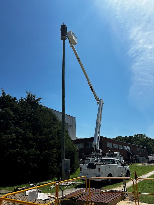 Equipment is set in place to work on one of the outdoor siren systems outside the Model and Machine Shop at Arnold Air Force Base, Tenn., as part of an ongoing siren system upgrade project occurring at the installation. When completed, 13 outdoor siren systems and 11 indoor siren systems located across Arnold AFB will be upgraded to improve the clarity of messages broadcast through the systems. These systems, collectively referred to as the Giant Voice System, transmit audible spoken messages, accompanied by sirens depending on the situation, whenever a situation that those across Arnold should be made aware of arises. These broadcasts can include alerts related to the weather, testing and emergency situations occurring on the installation. (U.S. Air Force photo)