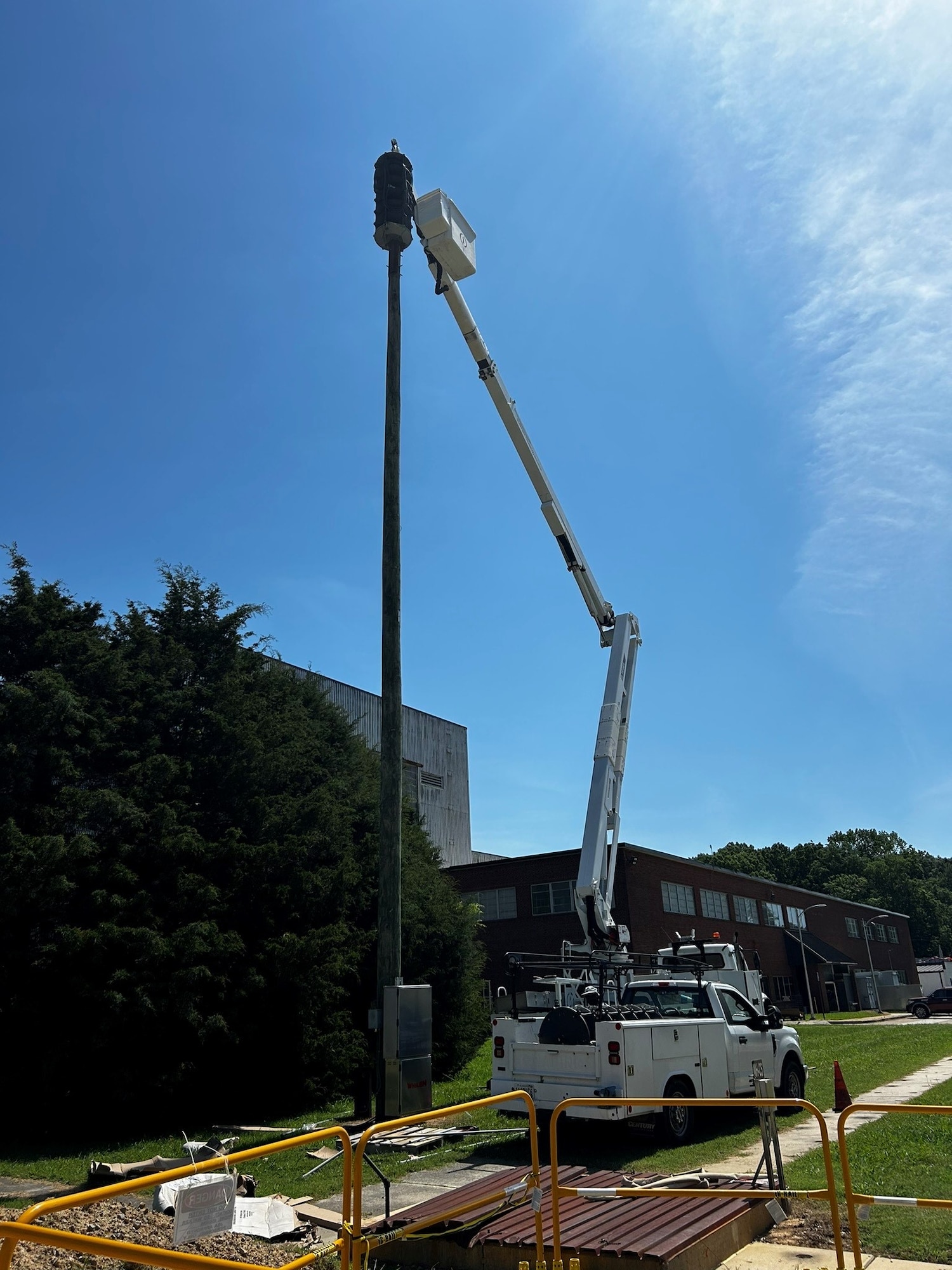 Equipment is set in place to work on one of the outdoor siren systems outside the Model and Machine Shop at Arnold Air Force Base, Tenn., as part of an ongoing siren system upgrade project occurring at the installation. When completed, 13 outdoor siren systems and 11 indoor siren systems located across Arnold AFB will be upgraded to improve the clarity of messages broadcast through the systems. These systems, collectively referred to as the Giant Voice System, transmit audible spoken messages, accompanied by sirens depending on the situation, whenever a situation that those across Arnold should be made aware of arises. These broadcasts can include alerts related to the weather, testing and emergency situations occurring on the installation. (U.S. Air Force photo)