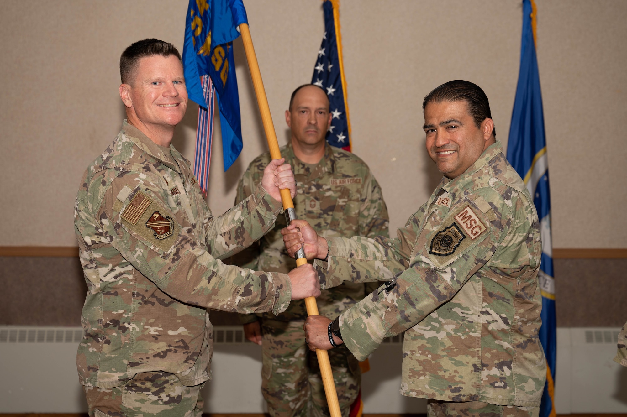 U.S. Air Force Col. Paul Townsend (left), 354th Fighter Wing commander, receives the guidon from Col. Tony Alvarado, 354th Mission Support Group outgoing commander, during the 354th MSG change of command ceremony at Eielson Air Force Base, Alaska, July 17, 2024.