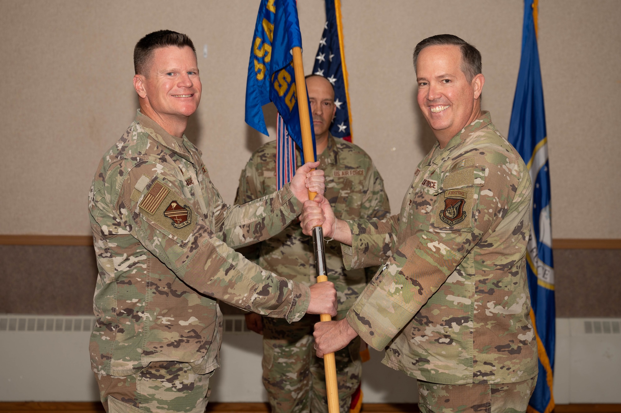 U.S. Air Force Col. Paul Townsend (left), 354th Fighter Wing commander, hands the guidon to Col. Timothy Foster, 354th Mission Support Group incoming commander, during the 354th MSG change of command ceremony at Eielson Air Force Base, Alaska, July 17, 2024.