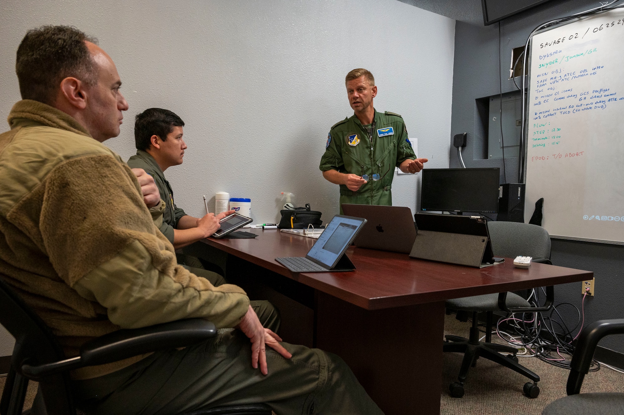 .S. Air Force Master Sgt. Ryan Snyder, 16th Training Squadron, plans and requirements superintendent, left, and U.S. Air Force Tech. Sgt. Isai Gil, 6th ATKS sensor operator instructor, center, rate the instructing capabilities of Royal Netherlands Air Force Chief Master Sgt. Paulus Janson, 6th Attack Squadron sensor operator instructor at Holloman Air Force Base, New Mexico, June 25, 2024. The purpose of this collaboration is for the 49th Wing to assist train MQ-9 Reaper pilots and sensor operators from the U.S. and allied nations, fostering international cooperation and ensuring consistent training standards for future NATO operations. (U.S. Air Force photo by Senior Airman Isaiah Pedrazzini)