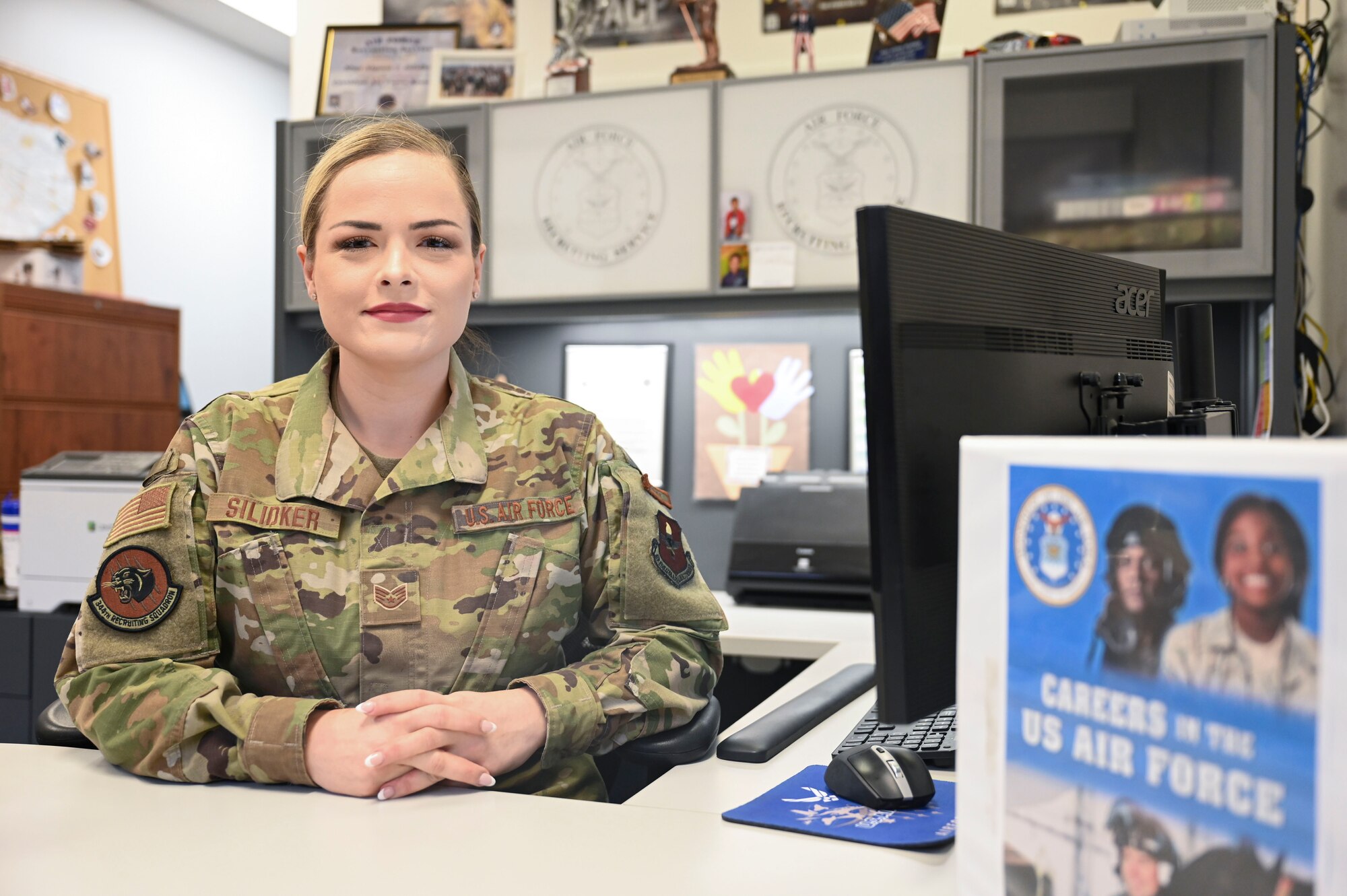 U.S. Air Force Staff Sgt. Alyson Silidker, 344th Recruiting Squadron enlisted accessions recruiter, smiles in her office at the San Angelo Air Force Recruiting office in San Angelo, Texas, July 3, 2024. Silidker has a passion for ensuring that her recruits are set up for success in their Air Force careers by pairing them with a job that fits them best. (U.S. Air Force photo by Airman 1st Class Madison Collier)