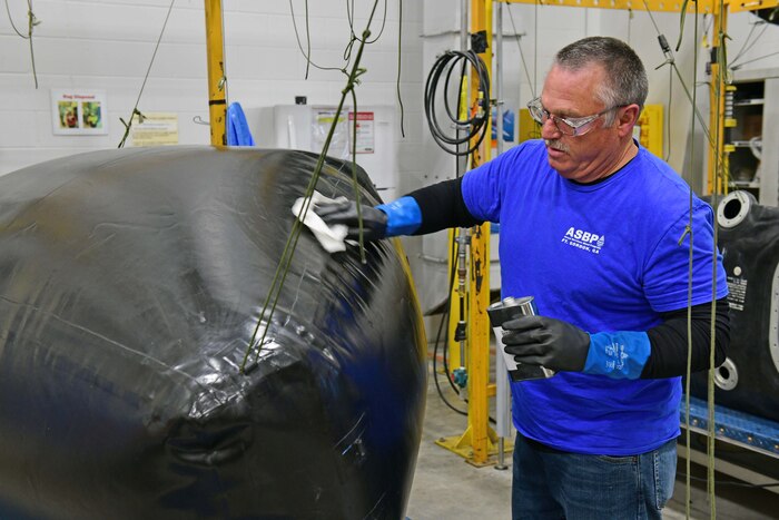 Man working on aircraft fuel bladder