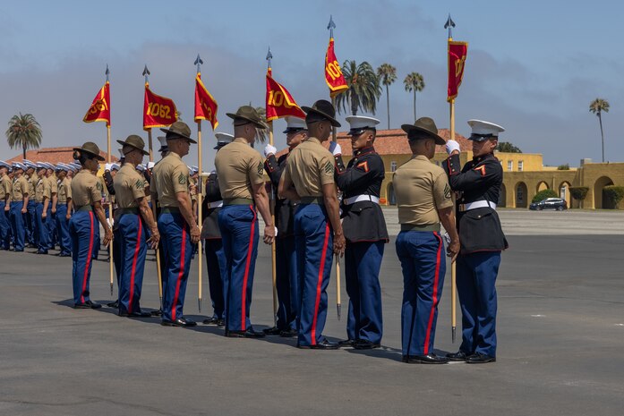 U.S. Marine Corps drill instructors with Delta Company, 1st Recruit Training Battalion, exchange the guidons during a graduation ceremony at Marine Corps Recruit Depot San Diego, California, July 19, 2024. Graduation took place at the completion of the 13-week transformation, which included training for drill, marksmanship, basic combat skills, and Marine Corps customs and traditions. (U.S. Marine Corps photo by Lance Cpl. Jacob B. Hutchinson)