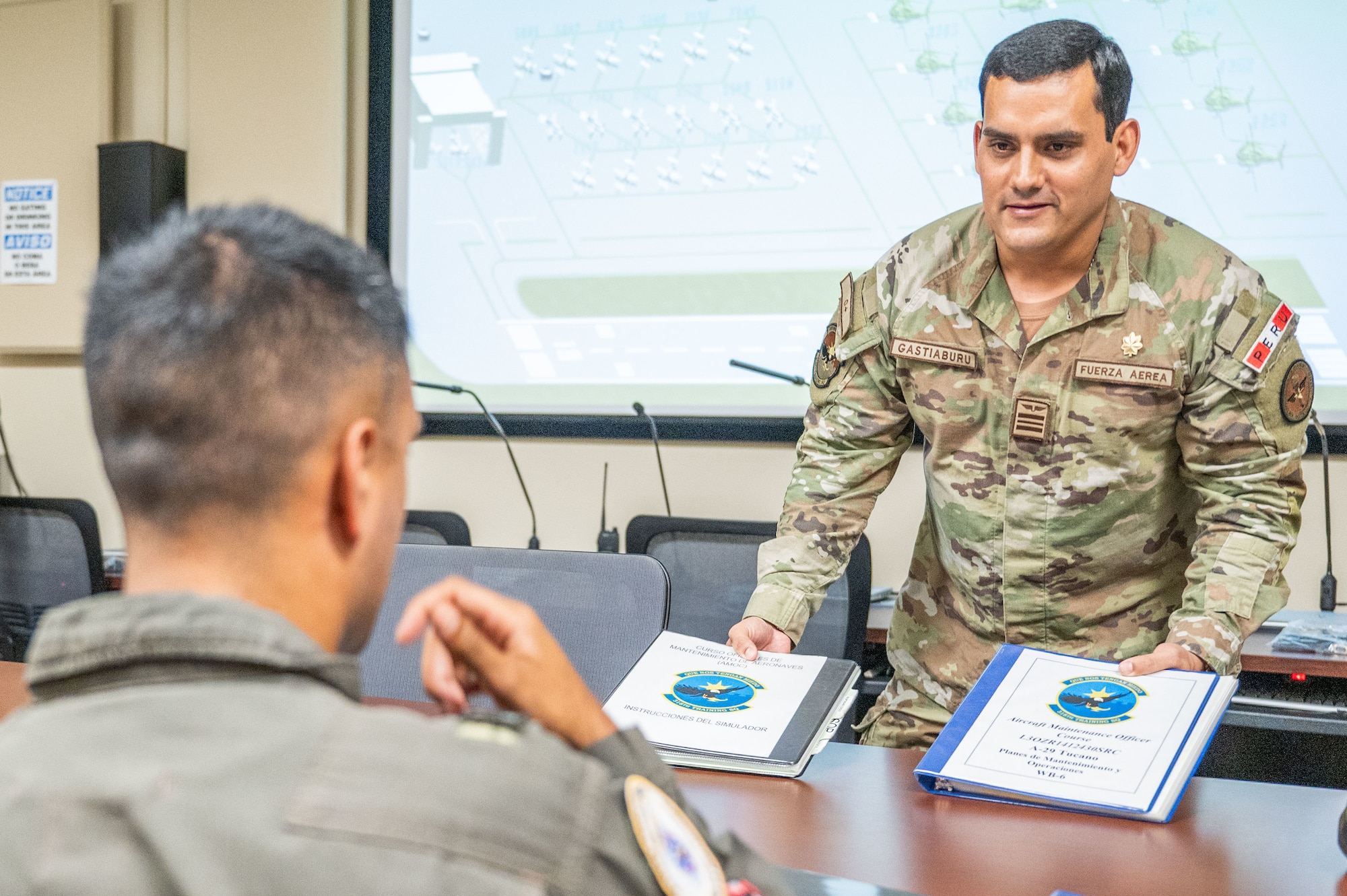 Maj. Jose Ricardo Gastiaburu, 837th Training Squadron, holds two training manuals during class at the Inter-American Air Forces Academy on Joint Base San Antonio-Lackland, Texas, May 31, 2024. Gastiaburu, a Partner Nation Instructor from the Peruvian Air Force, currently teaches IAAFA’s Aircraft Maintenance Officer Course to international military students. Gastiaburu is a graduate of the United States Air Force Academy. (U.S. Air Force photo by Vanessa R. Adame)