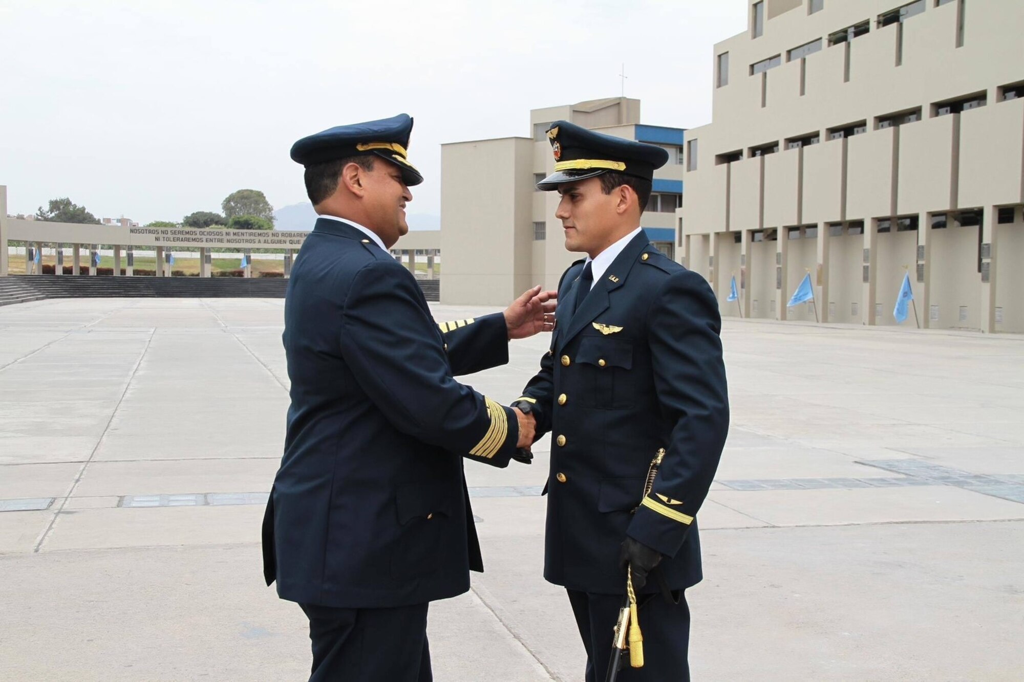 Col. Ricardo Gastiaburu shakes hands with cadet Jose Gastiaburu, both of the Peruvian Air Force, in Lima, Peru, Feb. 1, 2008. The younger Gastiaburu was a student at the air force academy in Peru when he learned he was selected for a scholarship at the U.S. Air Force Academy in Colorado Springs, Colorado. (Courtesy photo)