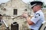 Air Force Trumpeter plays in front of the Alamo.