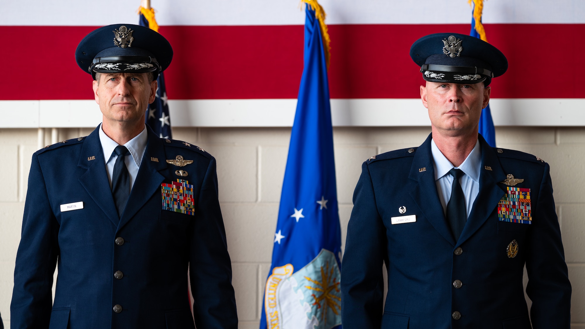 U.S. Air Force Maj. Gen. Corey Martin, 18th Air Force commander, left, and Col. Thomas Lankford, outgoing 317th Airlift Wing commander, stand at attention during the 317th AW change of command ceremony at Dyess Air Force Base, Texas, July 23, 2024. During the ceremony, Martin presented the Legion of Merit to Lankford for his distinguished service as the 317th AW commander. (U.S. Air Force photo by Airman 1st Class Jade M. Caldwell)