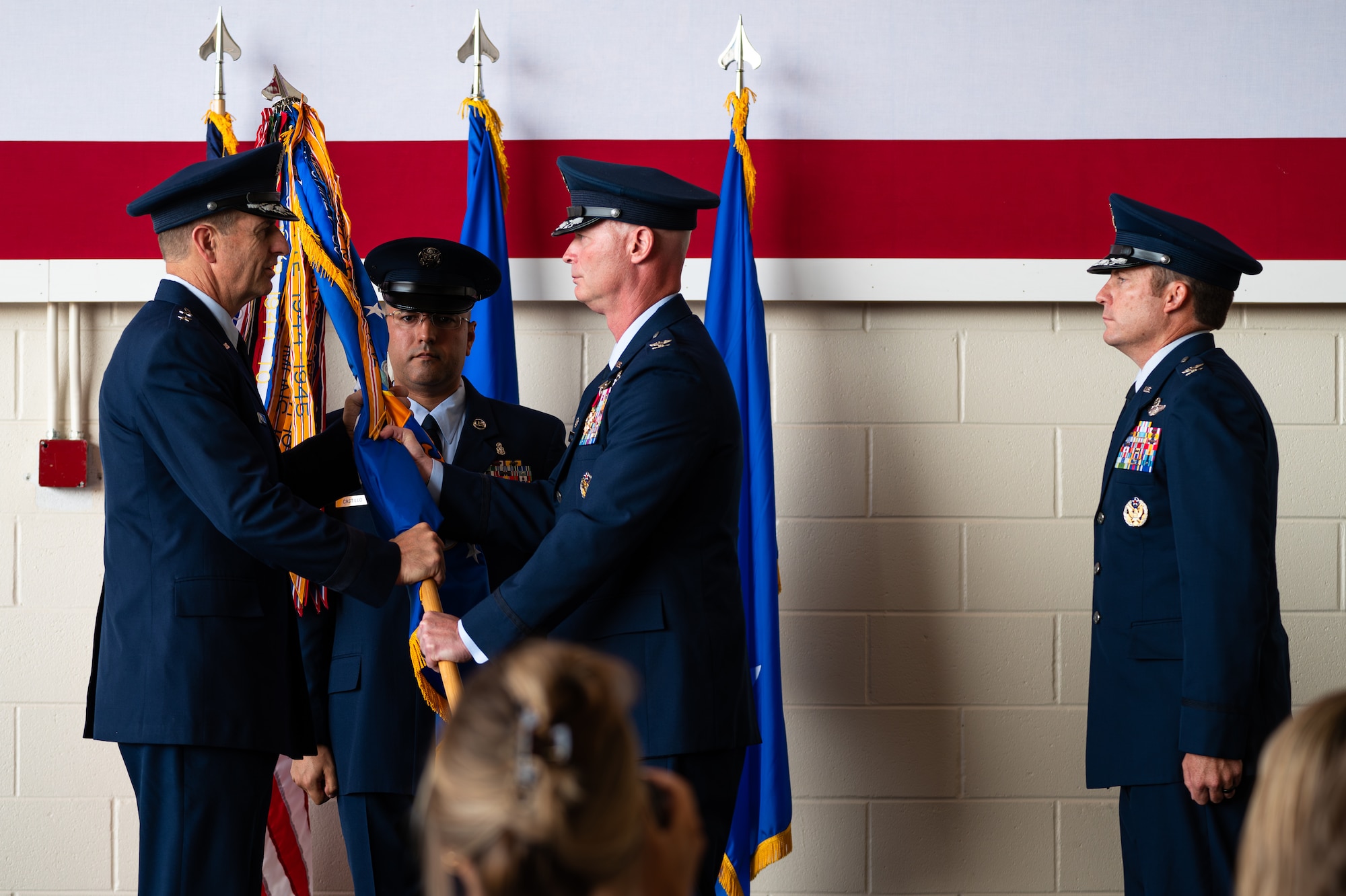 U.S. Air Force Maj. Gen. Corey Martin, 18th Air Force commander, left, accepts the guidon from Col. Thomas Lankford, 317th Airlift Wing outgoing commander, as he relinquishes command of the 317th AW at Dyess Air Force Base, Texas, July 23, 2024. The 317th AW commander is responsible for organizing, training, and equipping 1,200 combat-ready personnel who operate, maintain, and sustain Dyess’ C-130J aircraft. (U.S. Air Force photo by Airman 1st Class Jade M. Caldwell)
