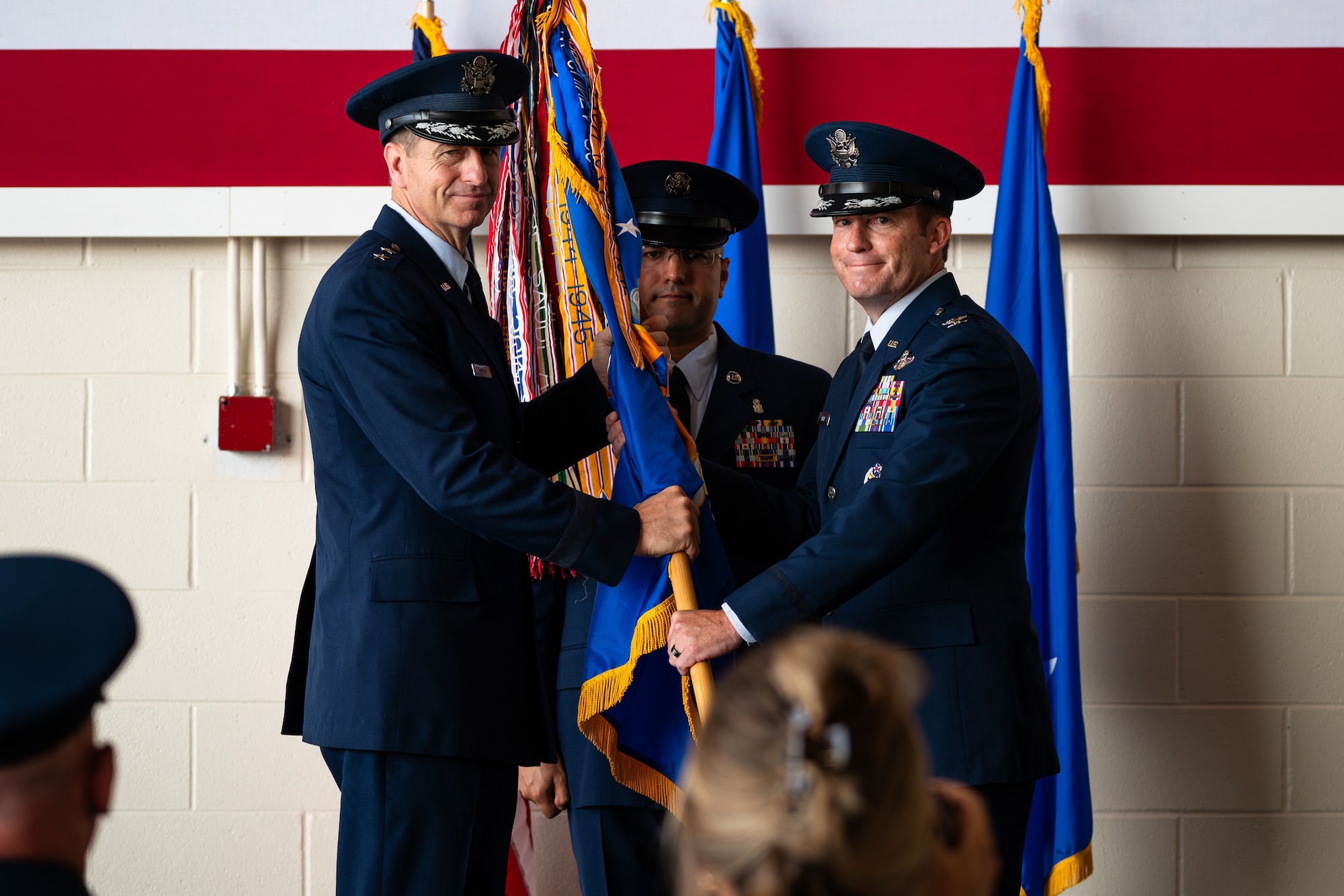 U.S. Air Force Maj. Gen. Corey Martin, 18th Air Force commander, left, passes the guidon to Col. Justin Diehl, as he assumes command of the 317th Airlift Wing during a change of command ceremony at Dyess Air Force Base, Texas, July 23, 2024. Diehl is a command pilot flying more than 3,400 hours and has flown 880 combat hours over six deployments executing missions for Operations Iraqi Freedom and Enduring Freedom. (U.S. Air Force photo by Airman 1st Class Jade M. Caldwell)