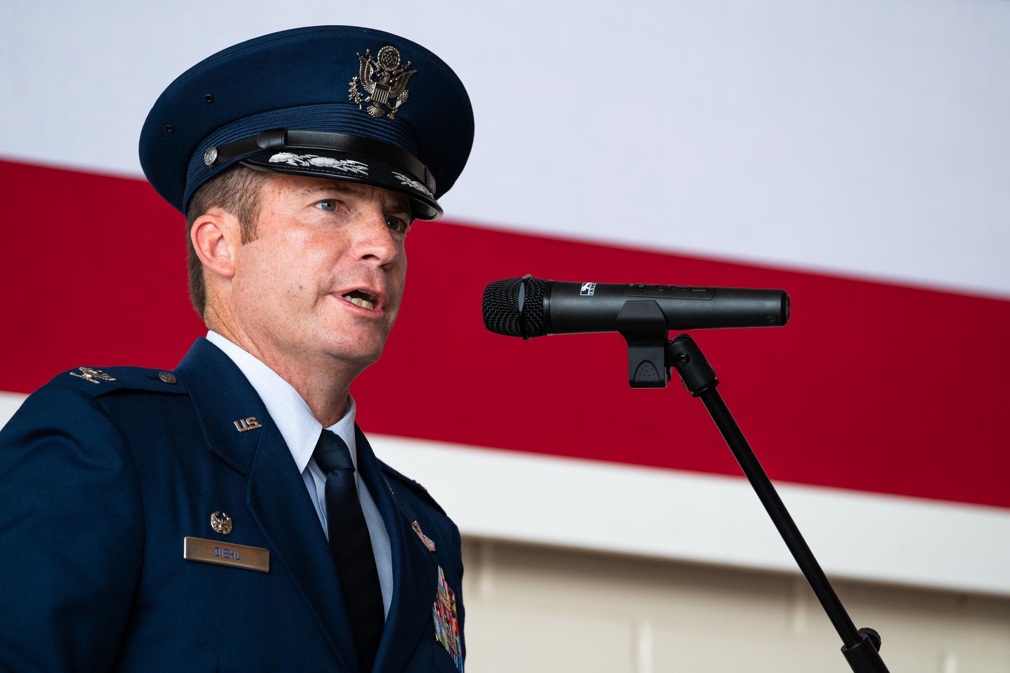 U.S. Air Force Col. Justin Diehl, 317th Airlift Wing commander, provides remarks during the 317th AW change of command ceremony at Dyess Air Force Base, Texas, July 23, 2024. Diehl, flying over 880 combat hours over six deployments, earned his commission from the United States Air Force Academy, Colorado Springs, Colorado, in 2001. (U.S. Air Force photo by Airman 1st Class Jade M. Caldwell)