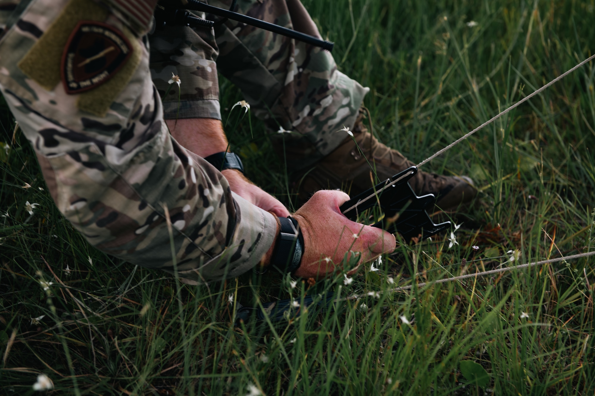 An Airman sets up an anchor point for a radio antenna.