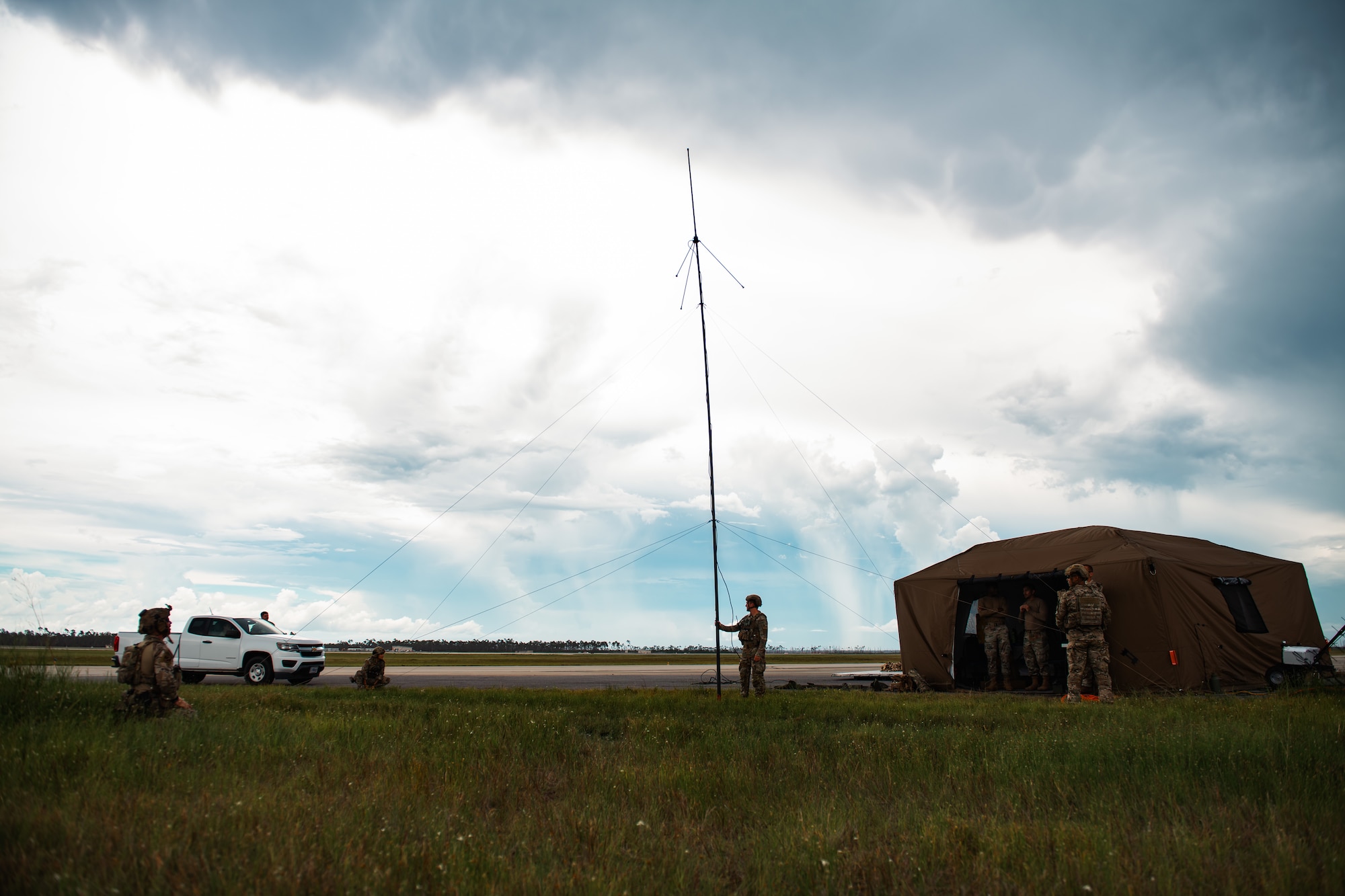 Airmen set up a radio antenna.
